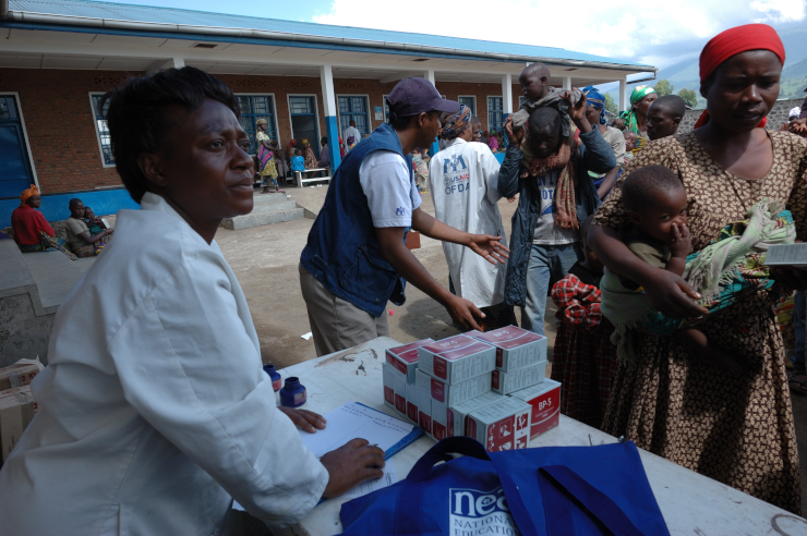 Workers passing out nutritional supplements
