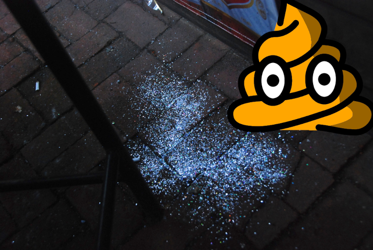 A front stoop covered in glitter with an orange-colored poop emoji in the background